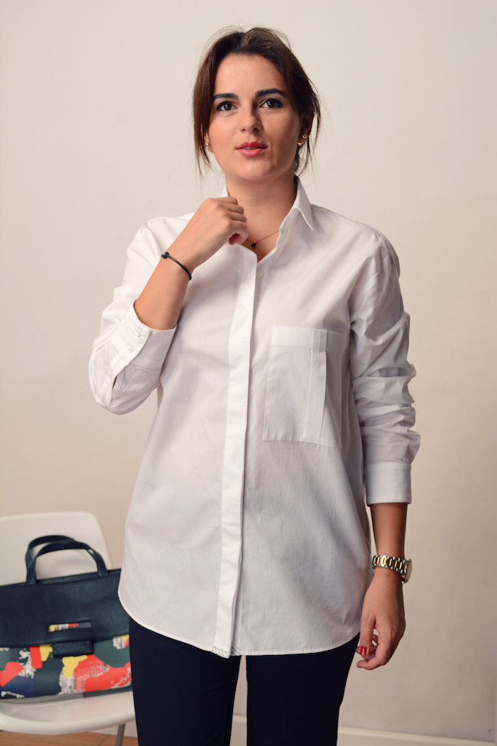 woman wearing a white button down in office look